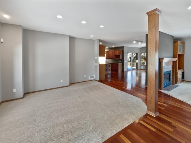 2412 132nd Ave NE, Blaine, MN 55449 - unfurnished living room with visible vents, recessed lighting, a fireplace, decorative columns, and baseboards
