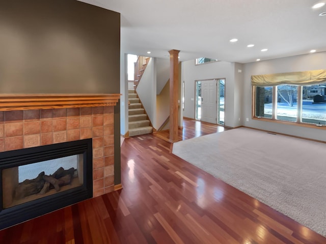 2412 132nd Ave NE, Blaine, MN 55449 - unfurnished living room with baseboards, a multi sided fireplace, stairway, recessed lighting, and wood finished floors