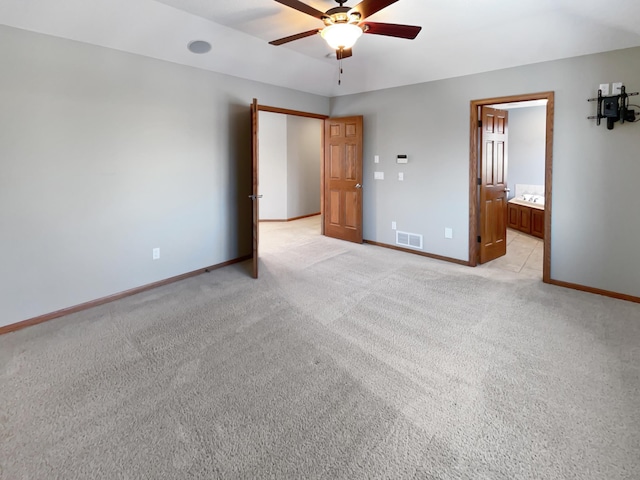 2412 132nd Ave NE, Blaine, MN 55449 - unfurnished bedroom with a ceiling fan, baseboards, visible vents, ensuite bathroom, and light carpet