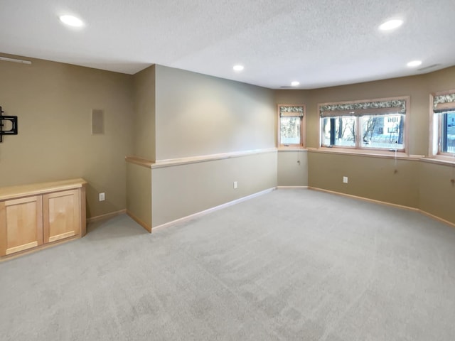 2412 132nd Ave NE, Blaine, MN 55449 - spare room with recessed lighting, light colored carpet, a textured ceiling, and baseboards