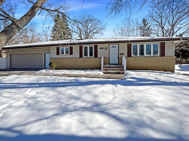 single story home with brick siding and an attached garage