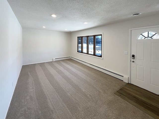 entryway featuring visible vents, a baseboard heating unit, carpet flooring, recessed lighting, and a textured ceiling