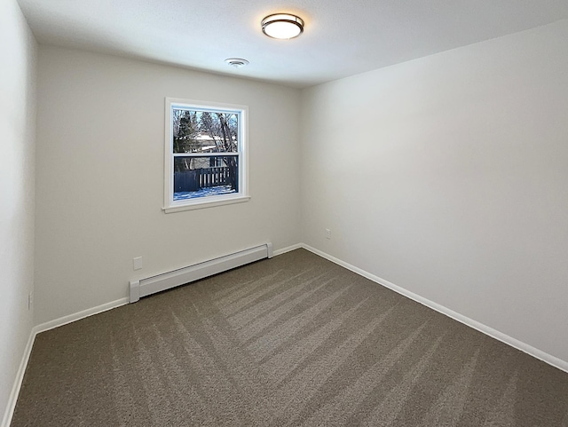 empty room with a baseboard radiator, baseboards, visible vents, and dark carpet