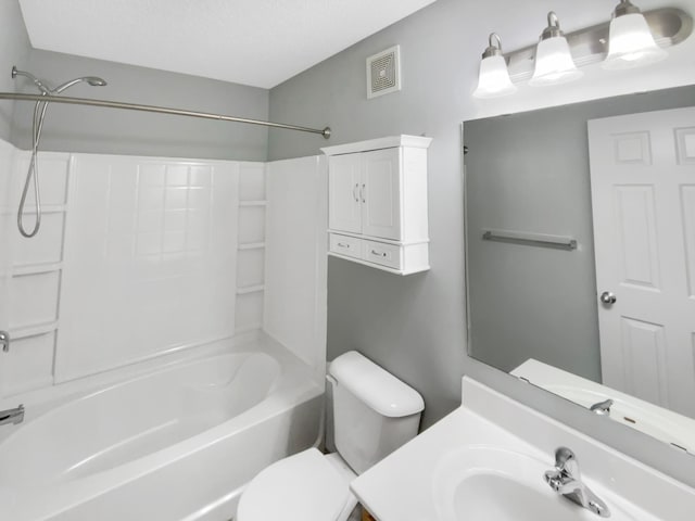 bathroom with visible vents, vanity, toilet, and shower / tub combination