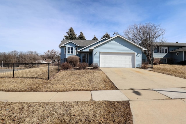 view of front of house featuring concrete driveway, fence, and a garage