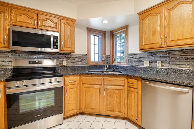 kitchen featuring a sink, decorative backsplash, and appliances with stainless steel finishes