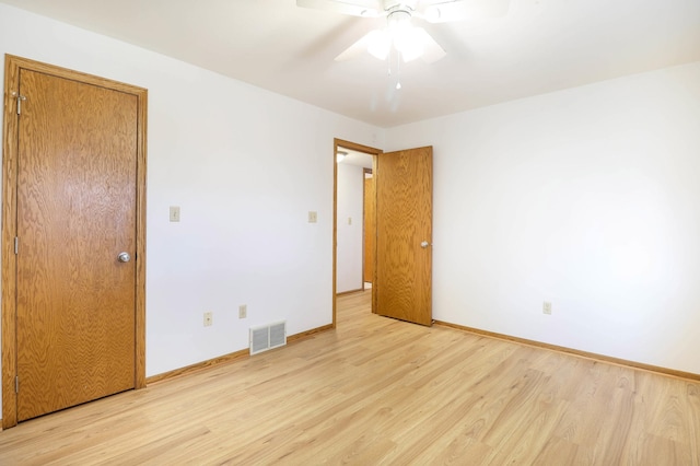 unfurnished bedroom featuring visible vents, baseboards, ceiling fan, and light wood finished floors