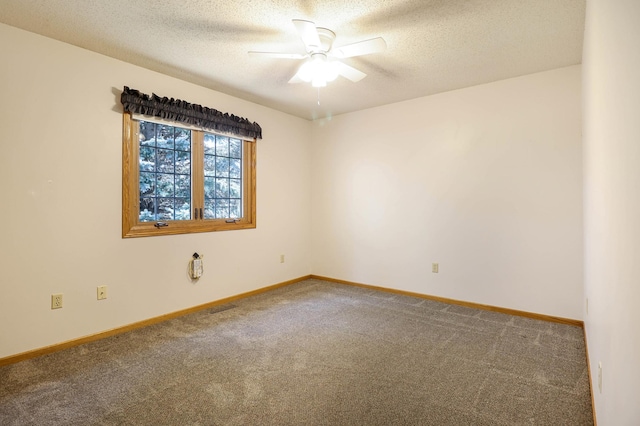 carpeted empty room with baseboards, a textured ceiling, and ceiling fan