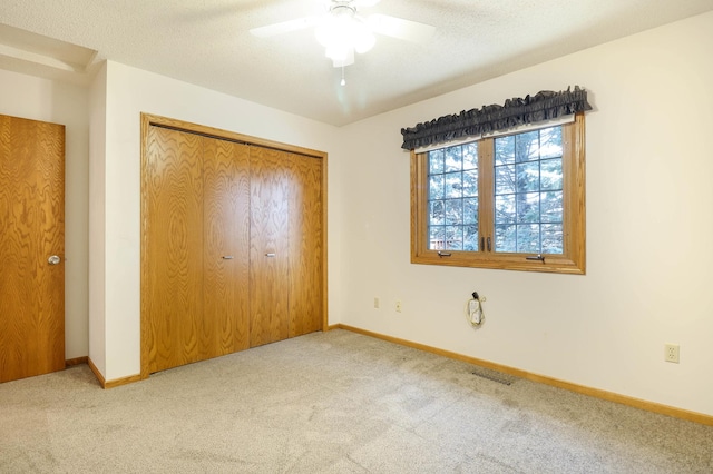 unfurnished bedroom featuring a closet, baseboards, carpet, and visible vents