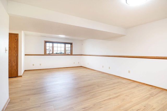 spare room featuring light wood-style flooring and baseboards