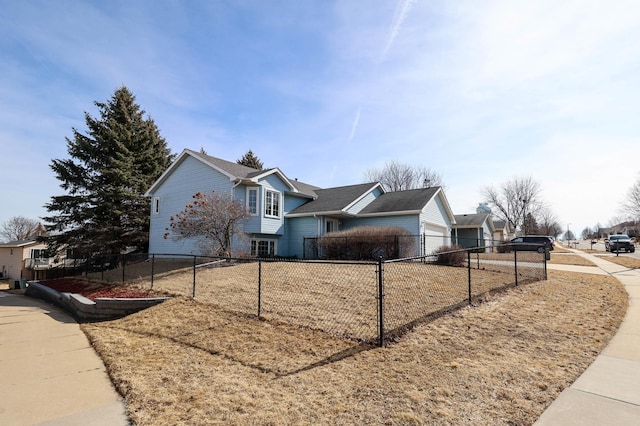 view of property exterior with a fenced front yard and an attached garage