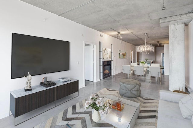 living area with a fireplace and a chandelier