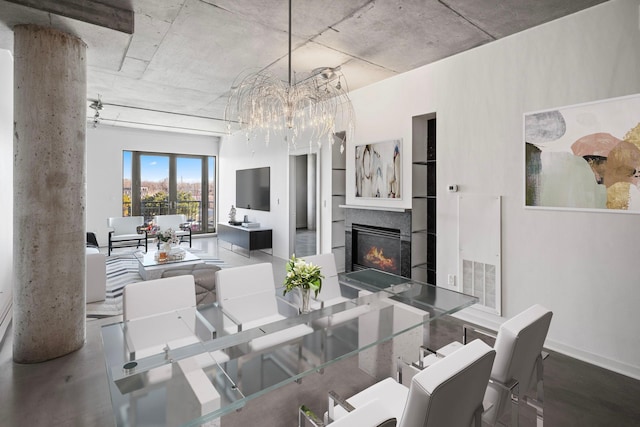 dining space featuring a notable chandelier, visible vents, and a lit fireplace