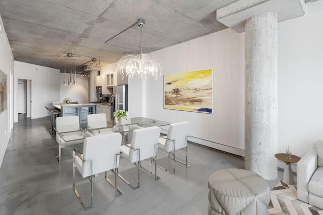 dining room featuring a baseboard heating unit, a notable chandelier, and concrete floors