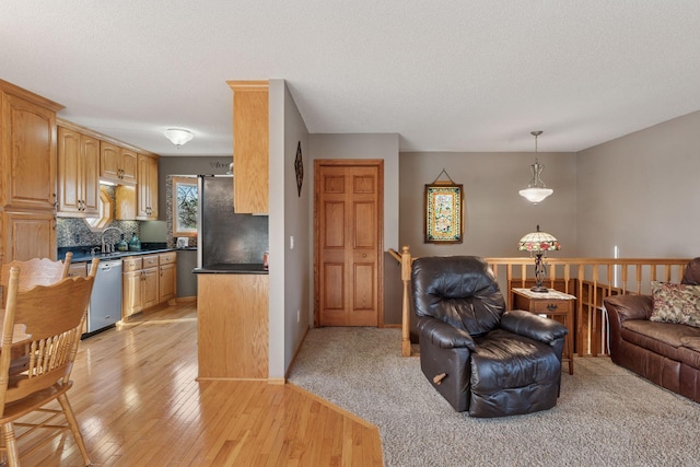 living area featuring a textured ceiling and light wood-type flooring