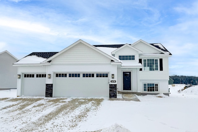 view of front of property featuring stone siding and a garage