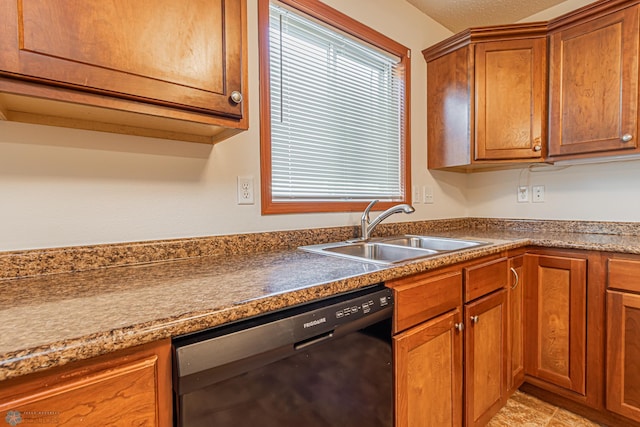 kitchen with dishwasher, brown cabinetry, and a sink