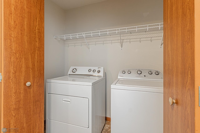 washroom with washer and clothes dryer and laundry area