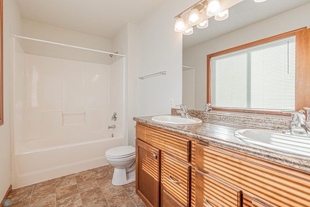 full bathroom with double vanity, toilet, shower / bathtub combination, and a sink