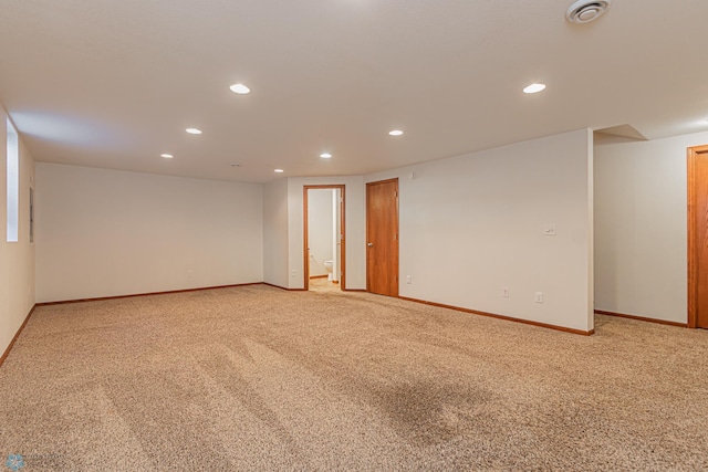 spare room featuring recessed lighting, visible vents, light colored carpet, and baseboards