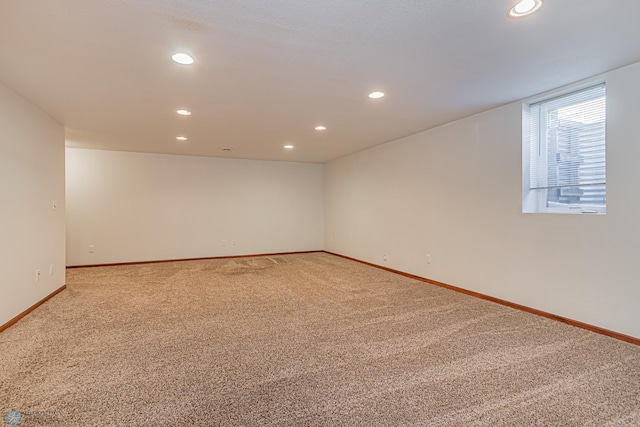 empty room with recessed lighting, baseboards, and light colored carpet