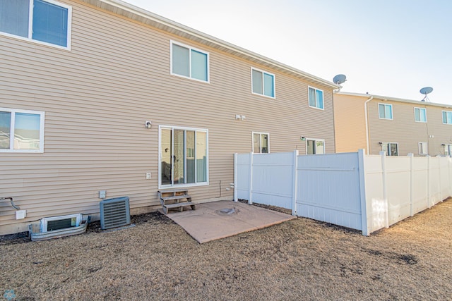 rear view of house featuring cooling unit, a patio, and fence