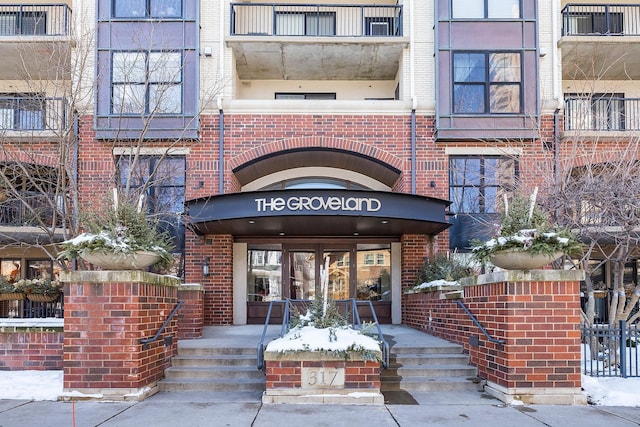 view of exterior entry with brick siding