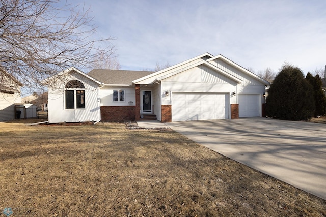 single story home featuring driveway, brick siding, an attached garage, and a front lawn