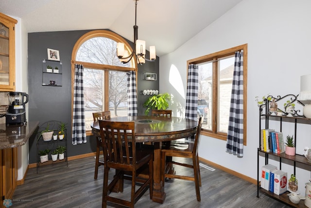 dining area featuring baseboards, an inviting chandelier, dark wood-style floors, and vaulted ceiling