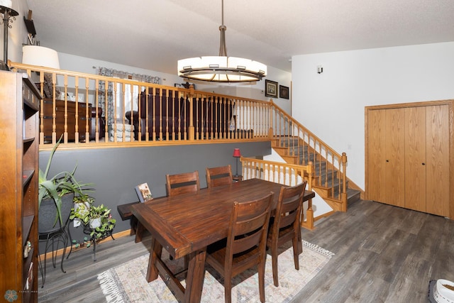 dining area featuring stairs, wood finished floors, and baseboards