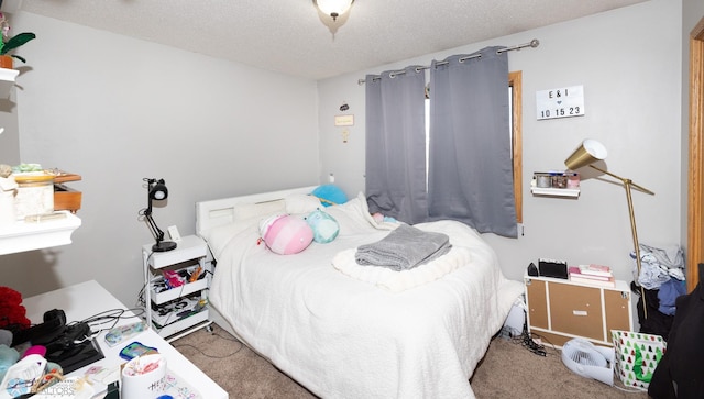 bedroom with carpet floors and a textured ceiling