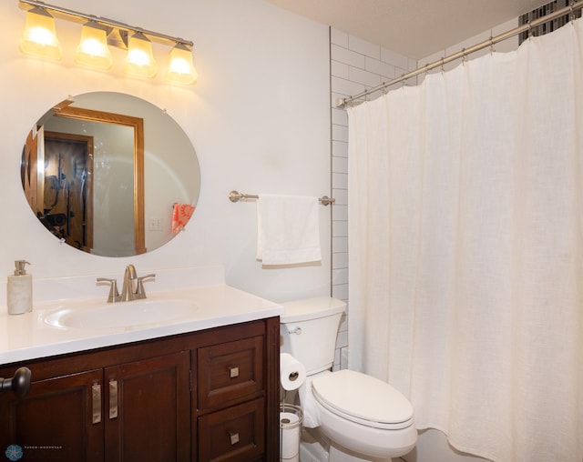 bathroom with toilet, vanity, and a shower with curtain