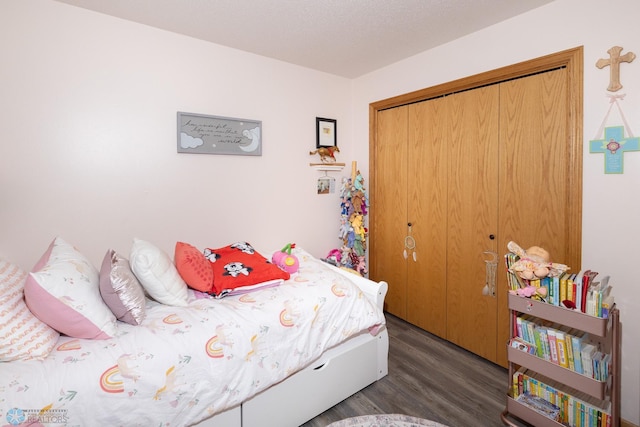 bedroom featuring wood finished floors and a closet