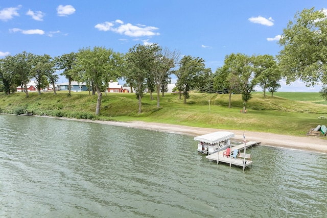 dock area featuring a lawn, a water view, and boat lift