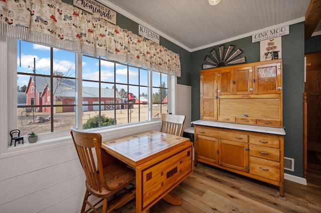 dining area featuring wooden ceiling, wood finished floors, visible vents, and ornamental molding