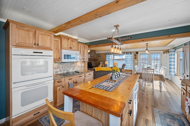 kitchen with butcher block countertops, beamed ceiling, white appliances, and hardwood / wood-style floors