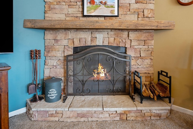 interior details with a stone fireplace, baseboards, and carpet floors