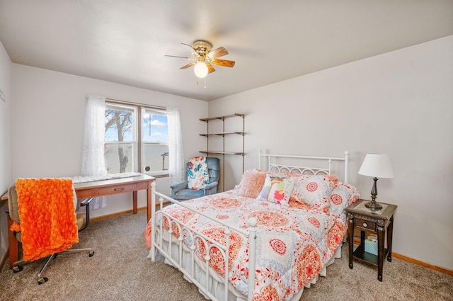 carpeted bedroom with a ceiling fan and baseboards