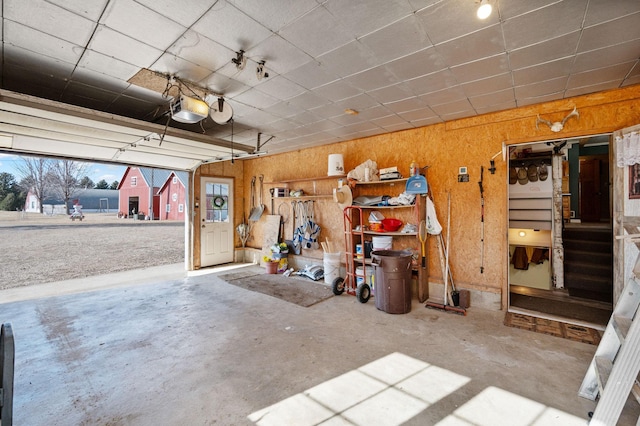 garage with wooden walls and a garage door opener