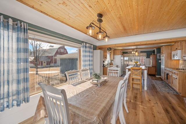 dining space featuring wooden ceiling and wood-type flooring