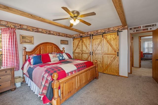 bedroom with baseboards, ceiling fan, light carpet, a barn door, and beamed ceiling