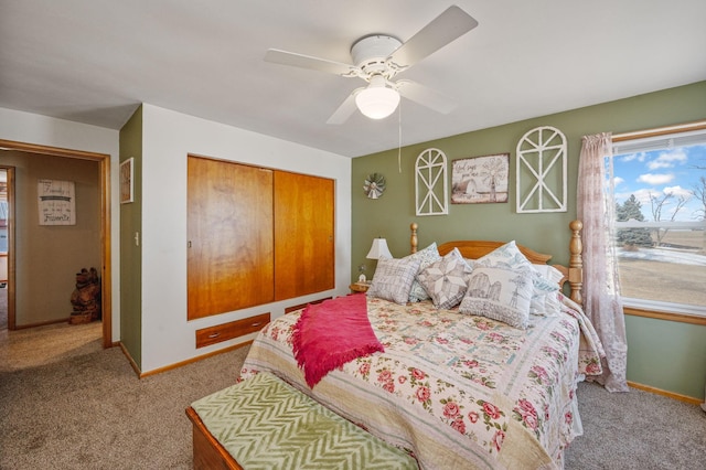 bedroom with a closet, baseboards, carpet, and ceiling fan