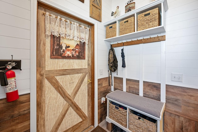 mudroom featuring wooden walls