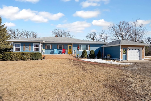 ranch-style home with a chimney, an attached garage, an outdoor structure, and a front lawn