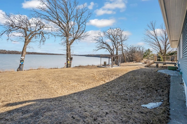 view of yard featuring a pergola and a water view