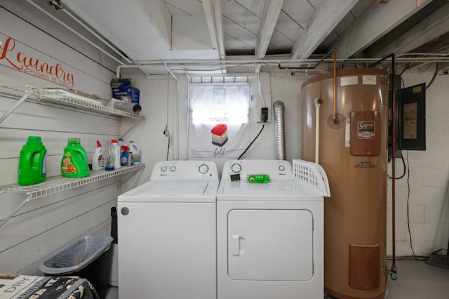 clothes washing area featuring washing machine and dryer, water heater, and laundry area