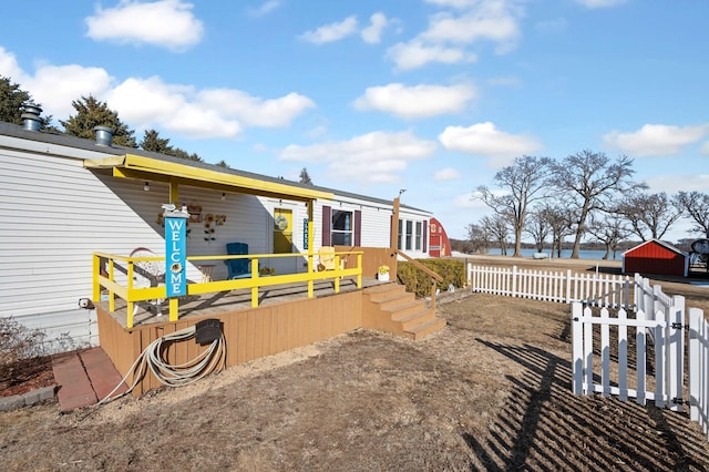 back of house featuring a deck and fence