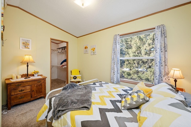 carpeted bedroom with vaulted ceiling, crown molding, a closet, and a textured ceiling