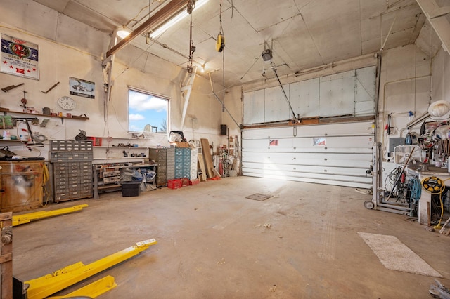 garage with a workshop area and a garage door opener