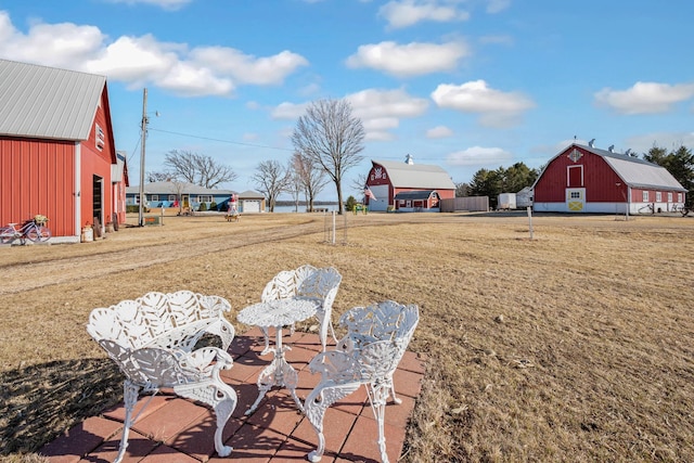 view of yard featuring an outbuilding, a barn, and a detached garage